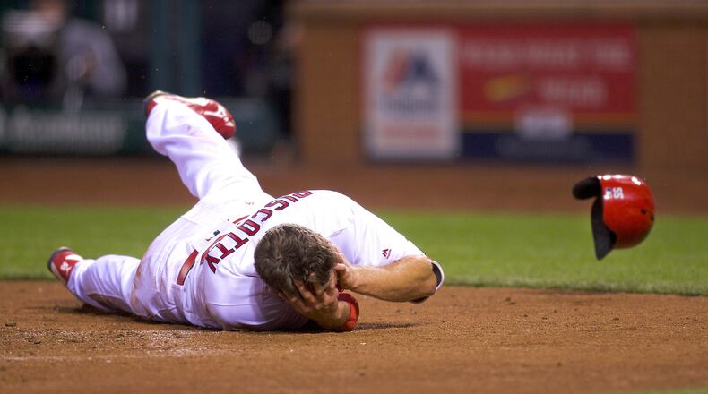 St. Louis Cardinals right fielder Stephen Piscotty gets hit by a throw in the bottom of the fifth inning during a Tuesday;'s baseball game between the St. Louis Cardinals and the Chicago Cubs.
