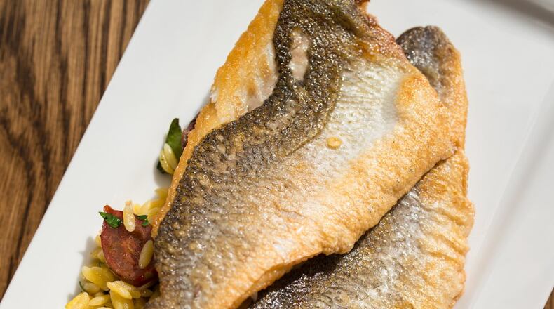 Mediterranea Pan-roasted Branzino with Mediterranean orzo. Photo credit- Mia Yakel.
