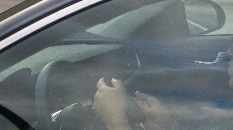 Legislative that could curb distracted driving is advancing in the Georgia House of Representatives. (FILE PHOTO BY ALYSSA POINTER/ALYSSA.POINTER@AJC.COM)