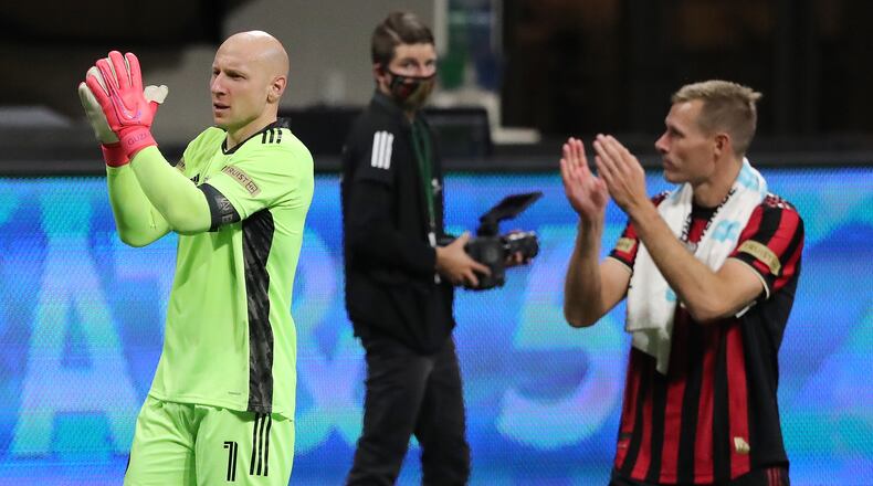 Atlanta United goalkeeper Brad Guzan (left) and forward Adam Jahn celebrate a 2-0 victory over Cincinnati Sunday, Nov. 1, 2020, at Mercedes-Benz Stadium in Atlanta. (Curtis Compton / Curtis.Compton@ajc.com)