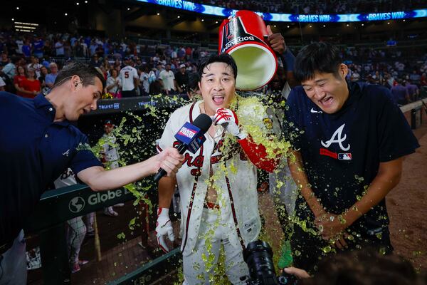 Braves shortstop Ha-Seong Kim (along with his interpreter and BravesVision's Wiley Ballard) got an early postgame shower Wednesday. (Miguel Martinez/ AJC)