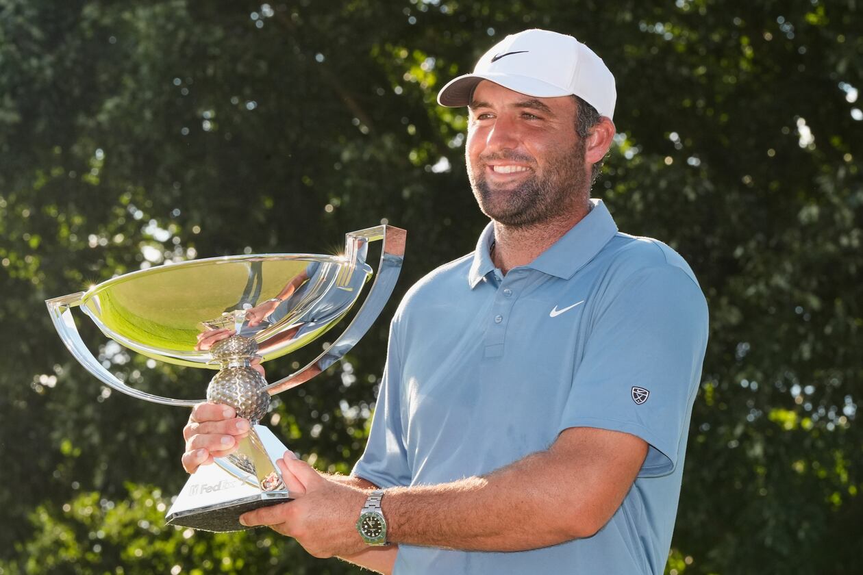 Scottie Scheffler holds the trophy after winning the PGA Tour Championship golf tournament Sunday, Aug. 30, 2026, in Atlanta. (AP Photo/Mike Stewart)
