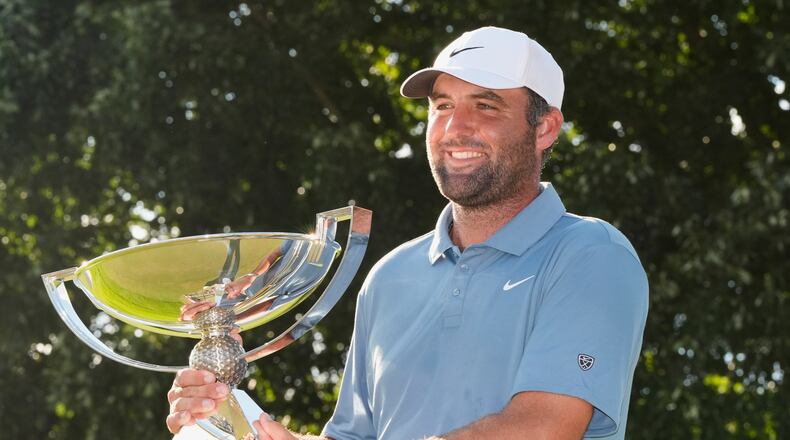 Scottie Scheffler holds the trophy after winning the PGA Tour Championship golf tournament Sunday, Aug. 30, 2026, in Atlanta. (AP Photo/Mike Stewart)