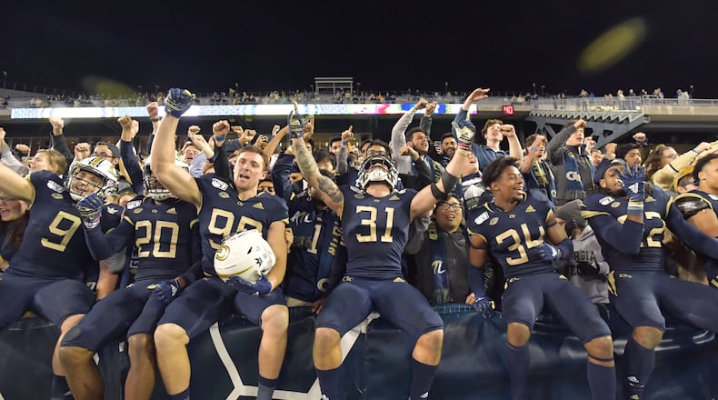 Georgia Tech players celebrate their victory over North Carolina State during an NCAA college football game at Bobby Dodd Stadium on Thursday, November 21, 2019. Georgia Tech won 28-26. (Hyosub Shin / Hyosub.Shin@ajc.com)