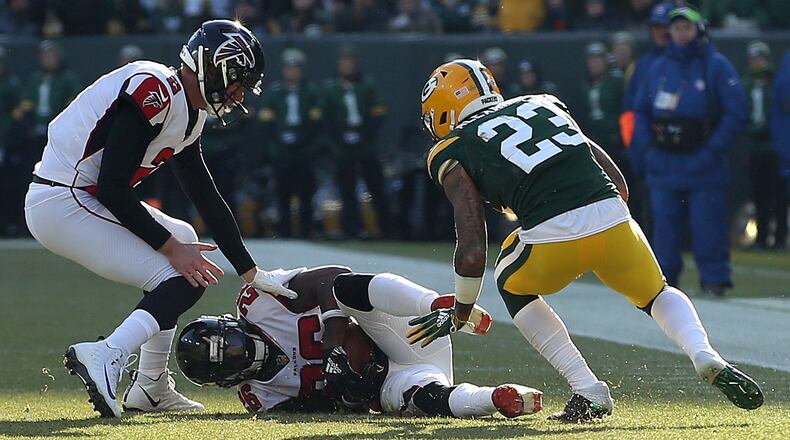 Tevin Coleman (26) of the Atlanta Falcons recovers a fumble during the first half of a game against the Green Bay Packers at Lambeau Field on December 09, 2018 in Green Bay, Wisconsin. (Photo by Dylan Buell/Getty Images)