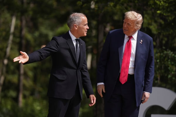 Canada Prime Minister Mark Carney, left, gestures as he welcomes President Donald Trump during the G7 Summit in Kananaskis, Alberta, Canada, Monday, June 16, 2025. (Darryl Dyck/The Canadian Press via AP)