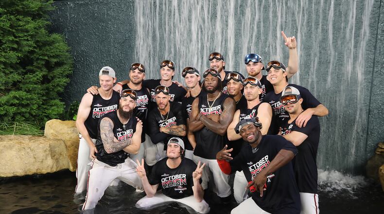 Atlanta Braves players take a dip in the outfield waterfall in celebration of clinching the National League East Friday night.