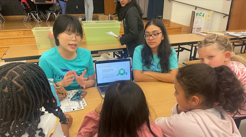 Northview High students Lydia Lee (right) and Riana Patel taught a lesson on glass recycling to Findley Oaks Elementary students. Courtesy