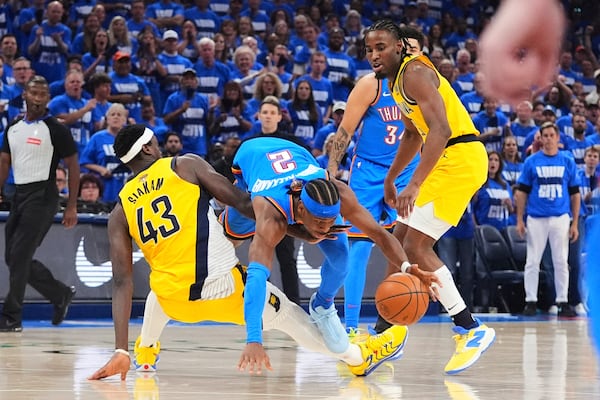 Indiana Pacers forward Pascal Siakam (43) collides with Oklahoma City Thunder guard Shai Gilgeous-Alexander (2) during the first half of Game 2 of the NBA Finals basketball series Sunday, June 8, 2025, in Oklahoma City. (AP Photo/Julio Cortez)
