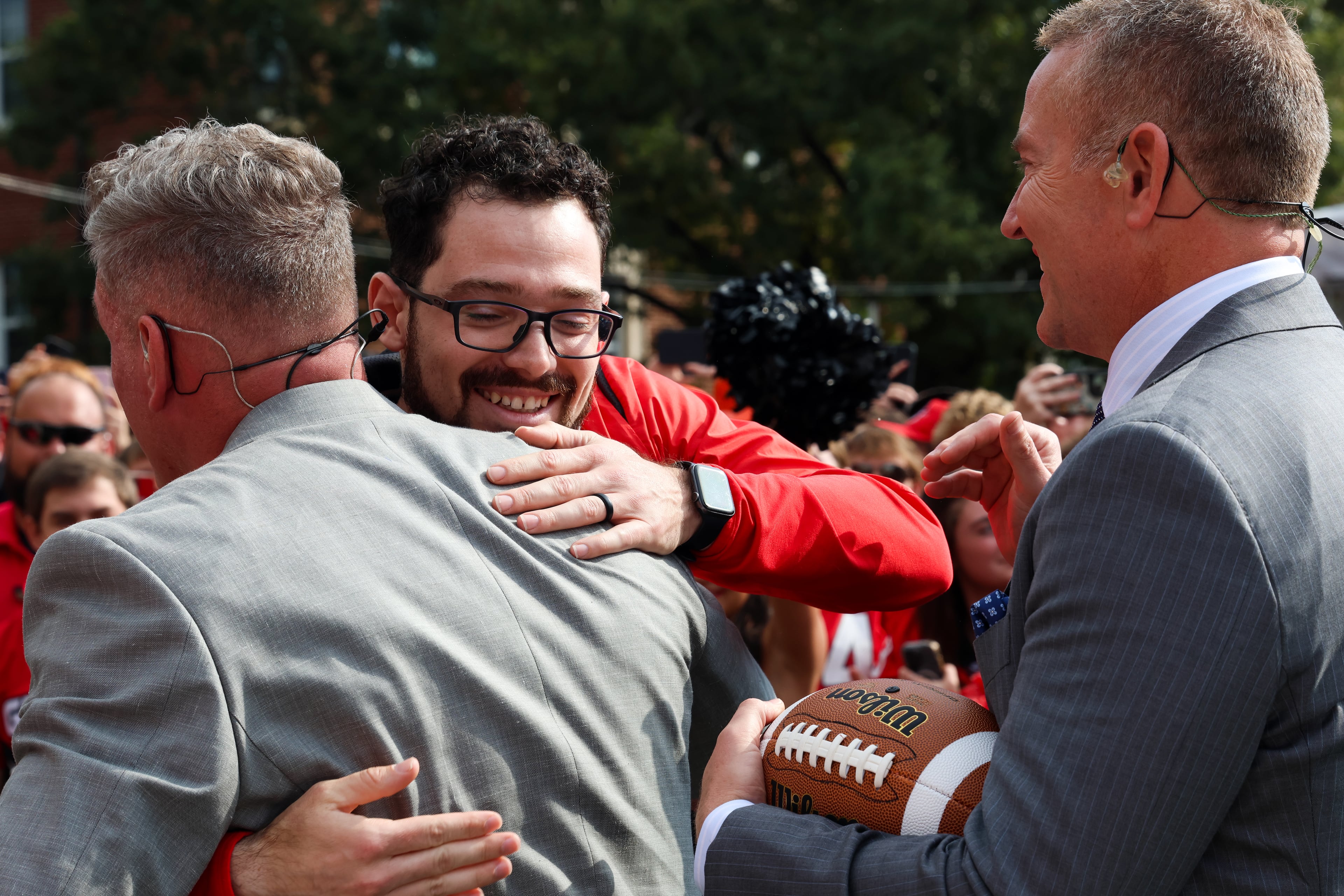 Former UGA kicker Rodrigo Blankenship (center) hugs Pat McAfee while Kirk Herbstreit (right) looks on during Pat McAfee’s Kicking Contest on the ESPN College GameDay broadcast from Myers Quad at UGA on Saturday, Oct. 18, 2025. (C.J. Bartunek for the AJC)