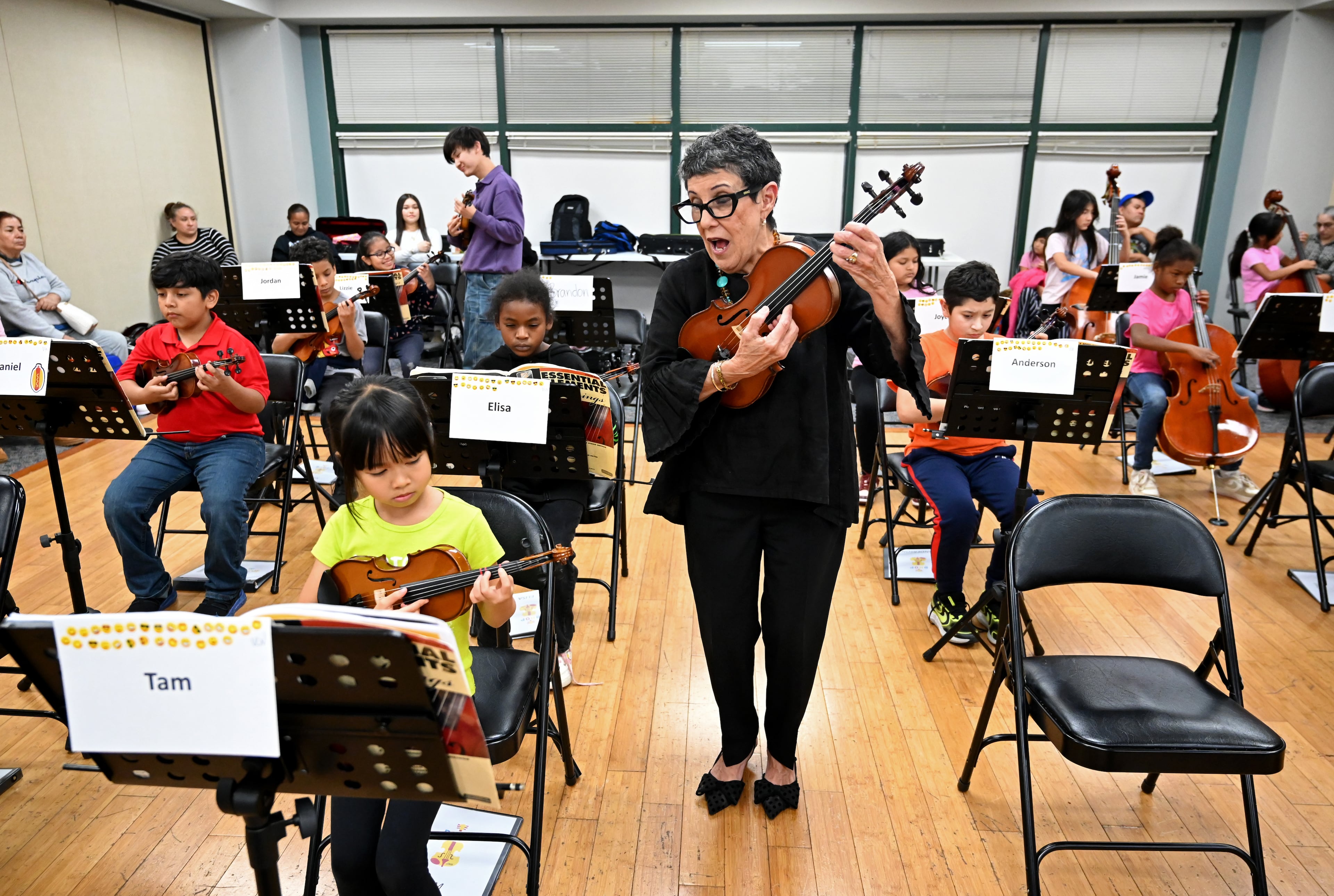 Juana Alzaga, director of Buford Highway Orchestra, works with her students.