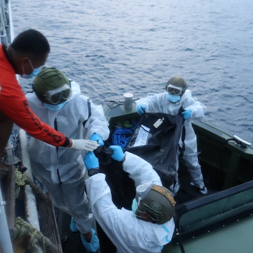 In this handout provided by the Philippine Coast Guard, rescuers transfer the remains of victims of the recent fire on the MV June Aster ferry on Friday Sept. 11, 2026 off Coron, Palawan province, western Philippines. (Philippine Coast Guard via AP)