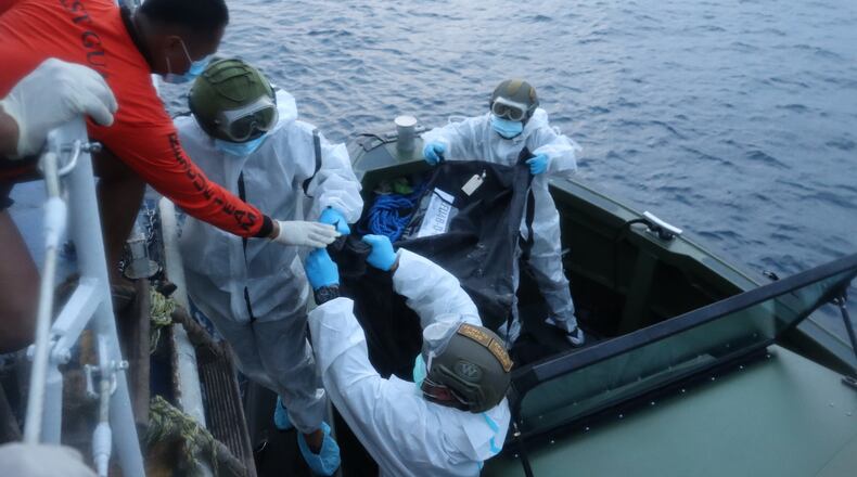 In this handout provided by the Philippine Coast Guard, rescuers transfer the remains of victims of the recent fire on the MV June Aster ferry on Friday Sept. 11, 2026 off Coron, Palawan province, western Philippines. (Philippine Coast Guard via AP)