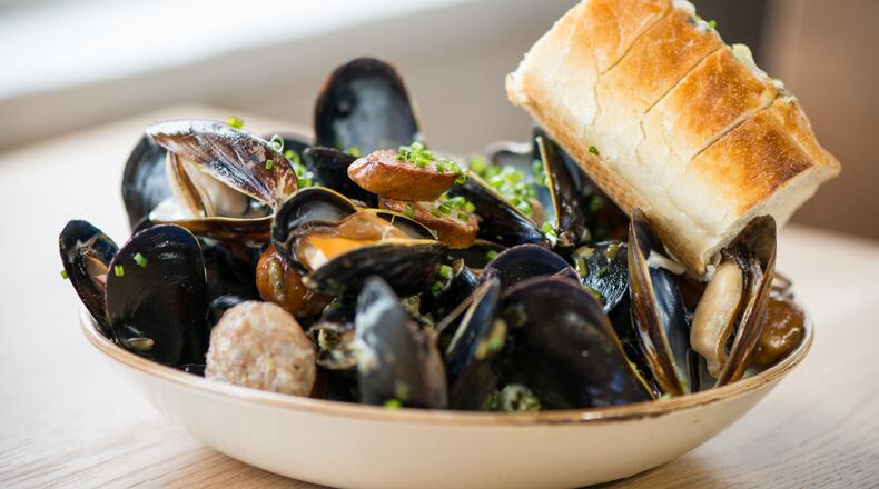 Dishes such as Bangs Island mussels with andouille, caper butter, and crusty bread await at Scout in Oakhurst. CONTRIBUTED BY MIA YAKEL