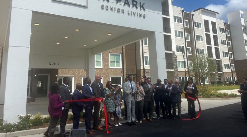 Mayor Andre Dickens and Councilmember Marci Collier Overstreet celebrate with developers in front of Briar Park senior living at Tuesday's ribbon-cutting ceremony.