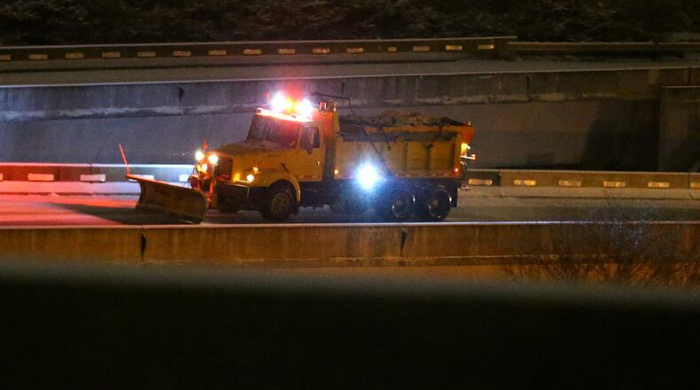 012814 ATLANTA: A DOT truck with a snow plow works to reopen the ice covered ramp from I-85 South to I-285 East at spagetti junction on Tuesday, Jan. 28, 2014, in Atlanta. CURTIS COMPTON / CCOMPTON@AJC.COM