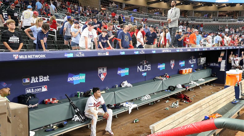 The last to leave the field Monday night, Braves infielder Johan Camargo sits in the dugout alone, contemplating the sudden end of the season.