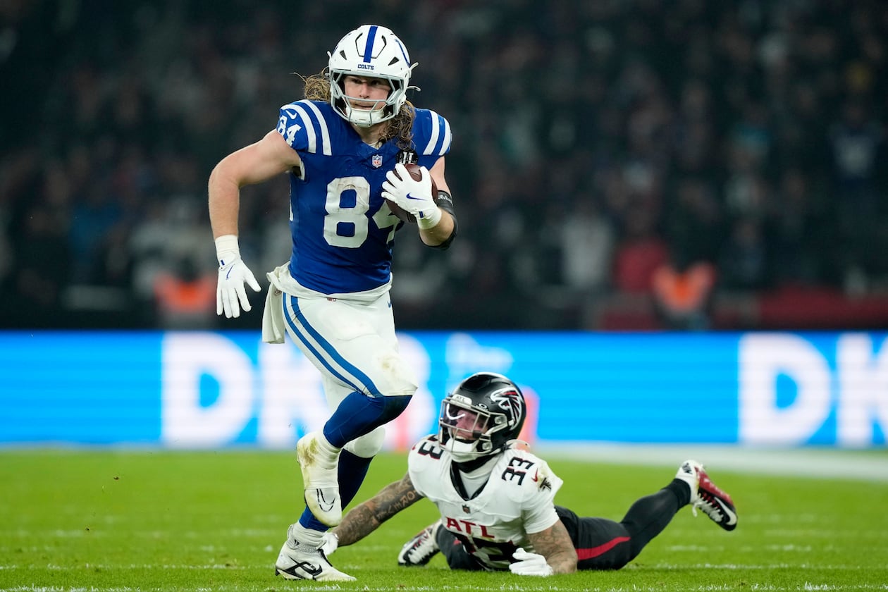 Indianapolis Colts tight end Tyler Warren (84) runs from Atlanta Falcons safety Billy Bowman Jr. (33) after catching a pass during the second half of an NFL football game, Sunday, Nov. 9, 2025, in Berlin, Germany. (AP Photo/Ebrahim Noorozi)