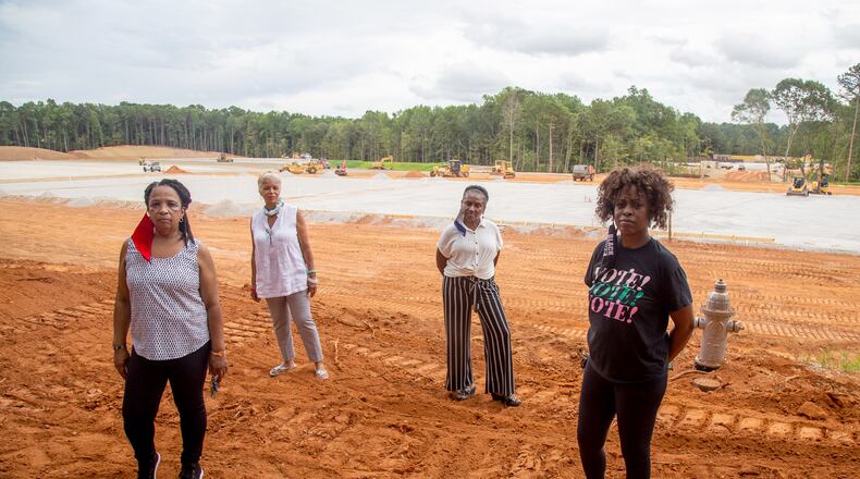 Stonecrest residents (from left to right) Renee Cail, Jake Bryant, Jennifer Wilson and Pyper Bunch at the construction site of the planned Metro Green concrete recycling plant, located across the street from a subdivision. STEVE SCHAEFER FOR THE ATLANTA JOURNAL-CONSTITUTION