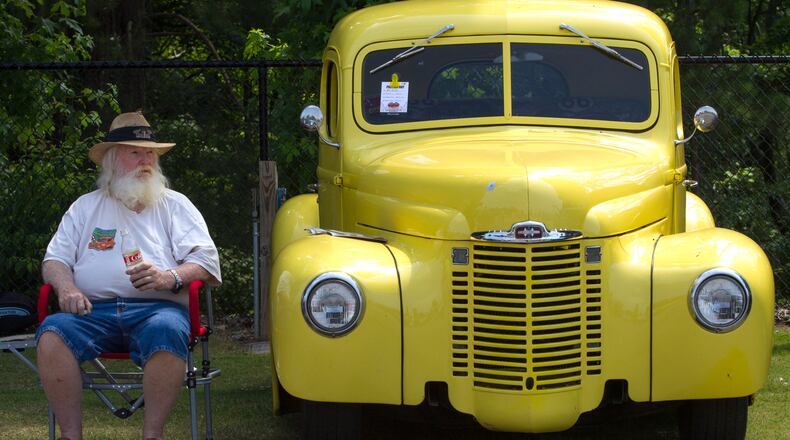 Mike Medley sits next to his 1948 international truck during the 28th annual Creepers Car Show at Jim R. Miller Park in Marietta on Saturday.