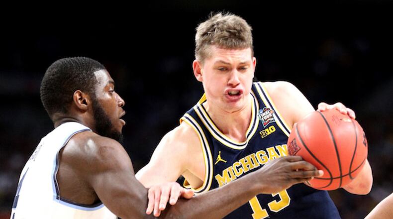 Michigan forward Moritz Wagner (13) drives to the basket against Villanova forward Eric Paschall (4) during the NCAA division 1 men's basketball national championship game between Michigan and Villanova on Monday, April 2, 2018, at the Alamodome in San Antonio, Texas. (Junfu Han/Detroit Free Press/TNS)