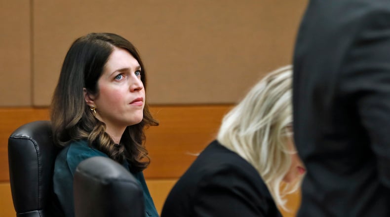 Jenna Garland (left) watches one of her attorneys, Scott Grubman, earlier this week as the court discussed guidelines for jury selection which began Monday in the first-ever criminal prosecution of an alleged violation of the Georgia Open Records Act. Jenna Garland, a former press secretary to ex-Atlanta Mayor Kasim Reed, was accused of ordering a subordinate to delay the release of water billing records requested by Channel 2 Action News that were politically damaging to Reed and other city elected officials. BOB ANDRES / BANDRES@AJC.COM