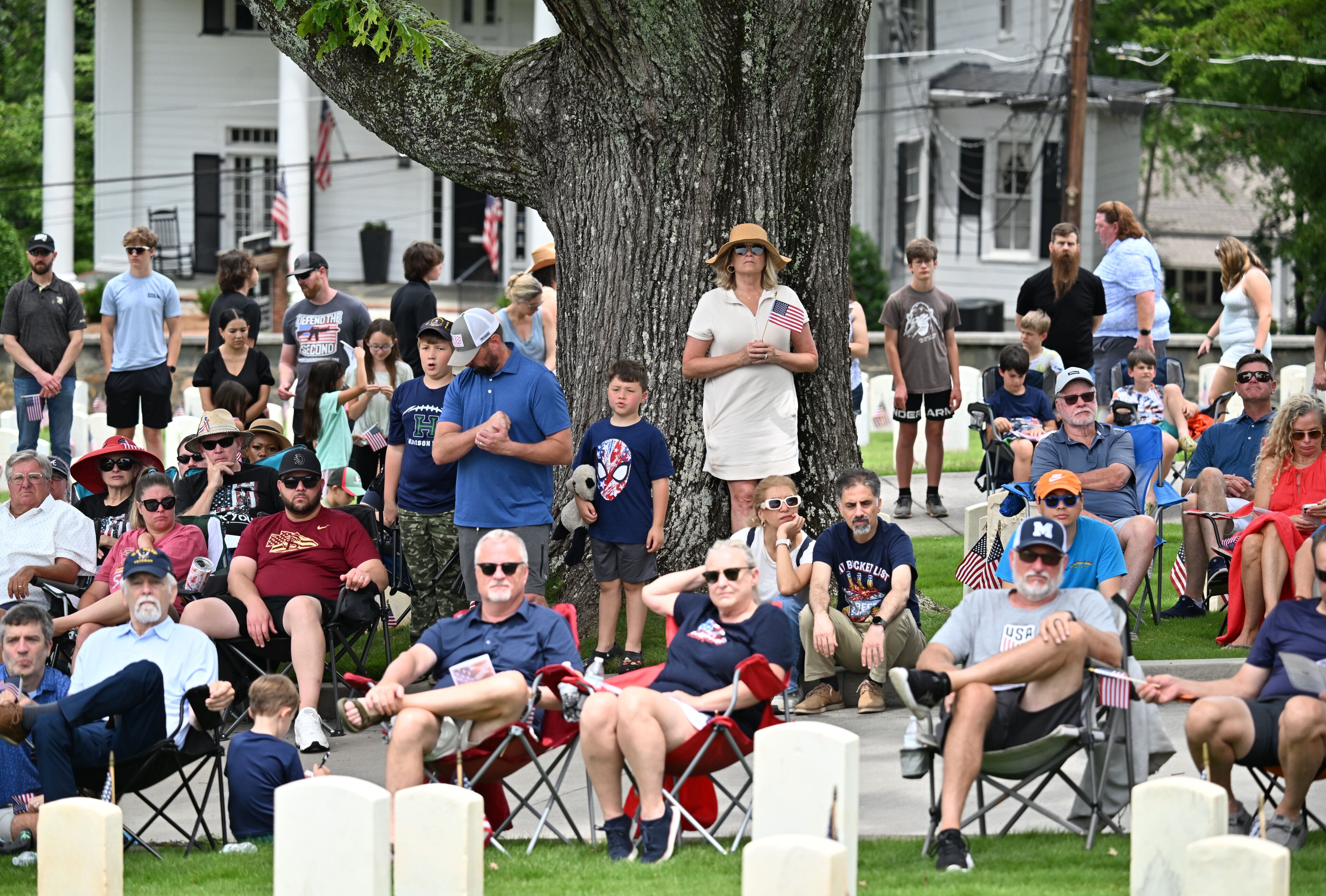Spectators watch during the Memorial Day ceremony at Marietta National Cemetery, Monday, May 26, 2025, in Marietta. (Hyosub Shin / AJC)
