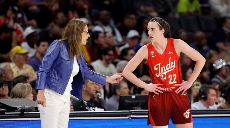 Indiana Fever head coach Stephanie White talks with Indiana Fever guard Caitlin Clark (22) during the first half of an WNBA basketball game against the Las Vegas Aces Sunday, July 12, 2026, in Las Vegas. (Steve Marcus/Las Vegas Sun via AP)