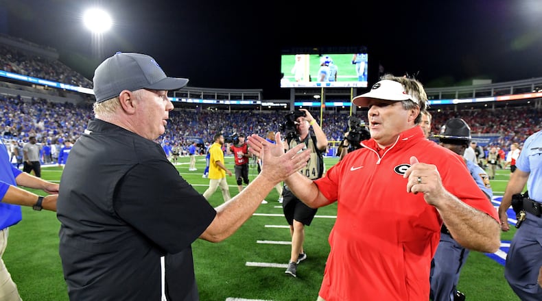 Georgia head coach Kirby Smart and Kentucky head coach Mark Stoops shake hands after Georgia beat Kentucky during an NCAA football game at Kroger Field, Saturday, September 14, 2024,  in Lexington, Kentucky. Georgia won 13-12 over Kentucky. (Hyosub Shin / AJC)