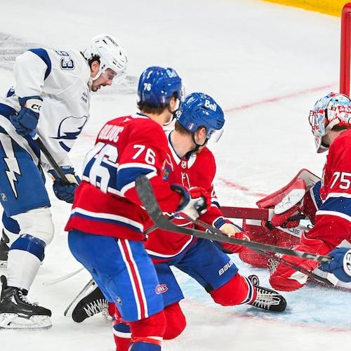 Tampa Bay Lightning's Gage Goncalves (93) scores against Montreal Canadiens goaltender Jakub Dobes (75) during overtime of Game 6 in the first round of an NHL hockey Stanley Cup playoff series in Montreal, Friday, May 1, 2026. (Graham Hughes/The Canadian Press via AP)