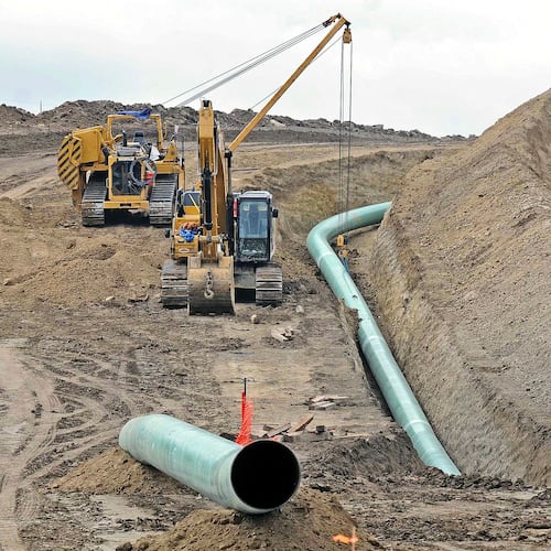 FILE - In this Oct. 5, 2016, file photo, heavy equipment is seen at a site where sections of the Dakota Access pipeline were being buried near the town of St. Anthony in Morton County, N.D. A federal judge on Monday, July 6, 2020, ordered the pipeline to shut down until more environmental review is done. (Tom Stromme/The Bismarck Tribune via AP, File)