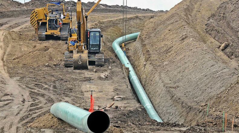 FILE - In this Oct. 5, 2016, file photo, heavy equipment is seen at a site where sections of the Dakota Access pipeline were being buried near the town of St. Anthony in Morton County, N.D. A federal judge on Monday, July 6, 2020, ordered the pipeline to shut down until more environmental review is done. (Tom Stromme/The Bismarck Tribune via AP, File)