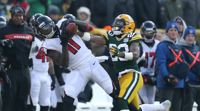 Julio Jones of the Atlanta Falcons catches a pass in front of Jaire Alexander of the Green Bay Packers during the first half of a game at Lambeau Field on December 09, 2018 in Green Bay, Wisconsin. (Photo by Dylan Buell/Getty Images)