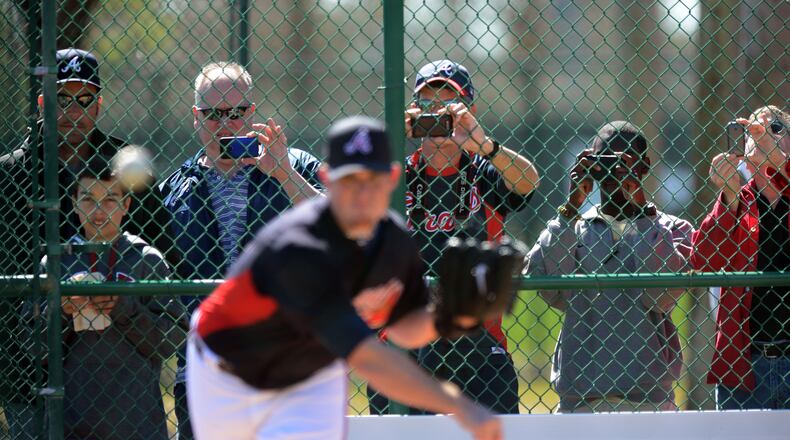 Braves fans snap pictures of Braves closer Craig Kimbrel as he works on his delivery.