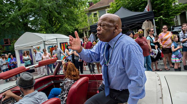 April 25, 2015 Atlanta - Congressman John Lewis blows kisses to the crowd as he rides in the parade during the Inman Park Festival in Atlanta on Saturday, April 25, 2015. The two day festival featured artists, musicians, food, a tour of homes, the parade and activities for children. JONATHAN PHILLIPS / SPECIAL