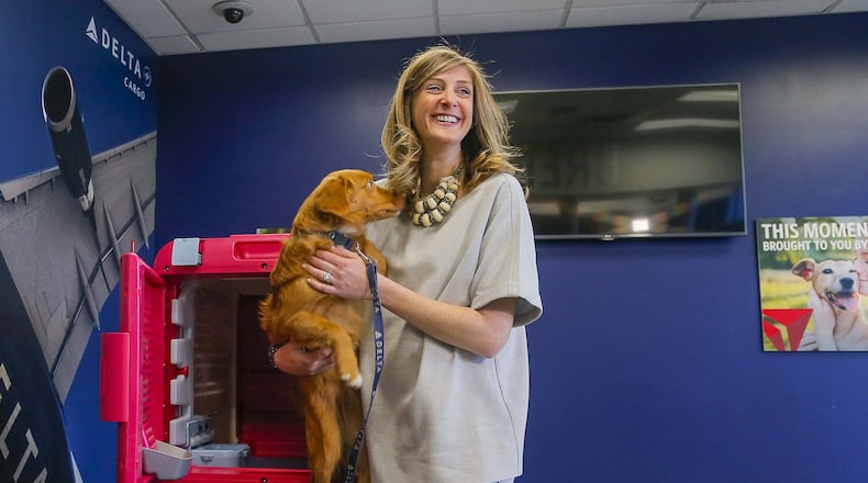 Delta Cargo Lead Product Manager Sara Bernhardt and her 5-month-old Nova Scotia Duck Tolling Retriever, Peach, introduce the CarePod. (ALYSSA POINTER/ALYSSA.POINTER@AJC.COM)