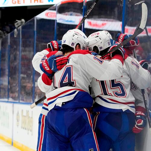 Montréal Canadiens center Alex Newhook (15) is mobbed by teammates, including Nick Suzuki (14) after scoring against the Tampa Bay Lightning during the third period in Game 7 of an NHL hockey Stanley Cup first-round playoff series, Sunday, May 3, 2026, in Tampa, Fla. (AP Photo/Chris O'Meara)
