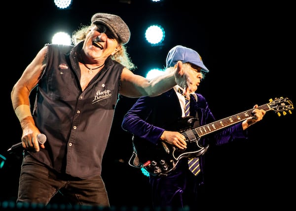 Every AC/DC song was a pile driver to the head, feeding that primal pleasure of a meaty guitar riff over a heavy drum beat and Brian Johnson’s (left) gritty falsetto. (Ryan Fleischer for the AJC)
