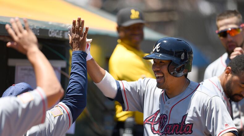Braves catcher Kurt Suzuki celebrates his solo home run Sunday in Oakland, giving the Braves an early lead. (Thearon W. Henderson/Getty Images)