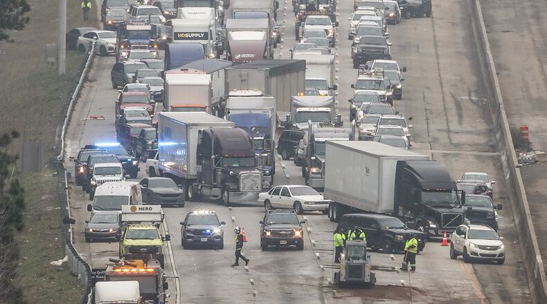 Multiple vehicles, including a dump truck and three tractor-trailers, were involved in the wreck on I-85 South near Flat Shoals Road. (John Spink / John.Spink@ajc.com)