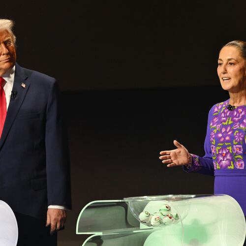 FILE - U.S. President Donald Trump looks on as Mexican President Claudia Sheinbaum speaks on stage at the draw for the 2026 soccer World Cup at the Kennedy Center in Washington, Dec. 5, 2025. (Mandel Ngan/Pool Photo via AP, File)