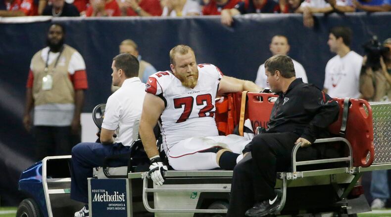 Atlanta Falcons' Sam Baker (72) leaves on a cart after he was injured during the second quarter of an NFL preseason football game against the Houston Texans, Saturday, Aug. 16, 2014, in Houston. (AP Photo/David J. Phillip)