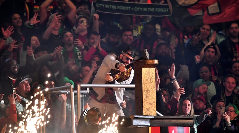 Tyree Simmons, professionally known as DJ Drama, hammers the gold spike to start the game against Portland Timbers in a MLS soccer match at Mercedes-Benz Stadium, Saturday, March 18, 2023, in Atlanta. Atlanta United won 5-1 over Portland Timbers. (Hyosub Shin / Hyosub.Shin@ajc.com)