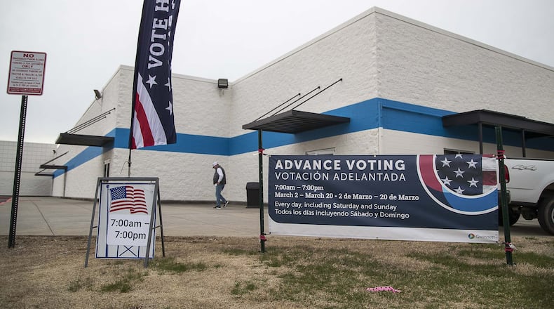 Signs for early voting are displayed in March outside the Gwinnett Voter Registrations and Elections office building in Lawrenceville. (ALYSSA POINTER/ALYSSA.POINTER@AJC.COM)