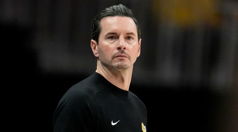 Los Angeles Lakers head coach JJ Redick watches play against the Atlanta Hawks during the second half of an NBA basketball game, Saturday, Nov. 8, 2025, in Atlanta. (AP Photo/Mike Stewart)