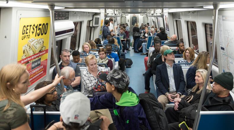 Passengers ride a red line train at the North Springs MARTA Station on Friday. (DAVID BARNES / DAVID.BARNES@AJC.COM)