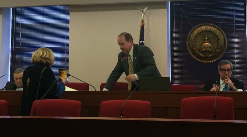 Rep. Buzz Brockway talks with Rep. Michele Henson before voting to table legislation creating the city of Greenhaven. Reps. Hugh Floyd, left, and Tom Taylor, right, joined Brockway in voting against the bill. MARK NIESSE / MARK.NIESSE@AJC.COM