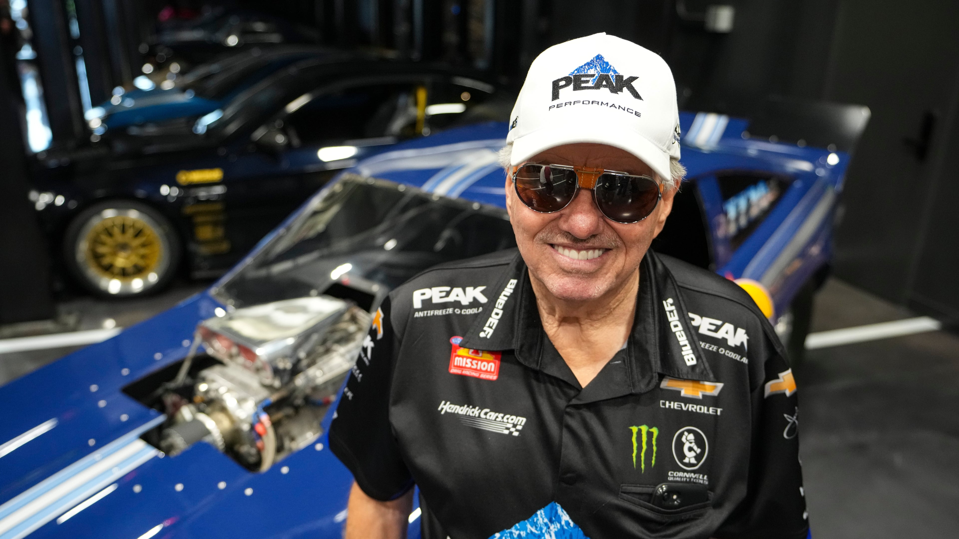 FILE - Drag racing car owner John Force poses next to his original funny car, Aug. 28, 2025, in Zionsville, Ind. (AP Photo/Michael Conroy, File)