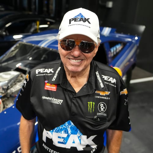 FILE - Drag racing car owner John Force poses next to his original funny car, Aug. 28, 2025, in Zionsville, Ind. (AP Photo/Michael Conroy, File)