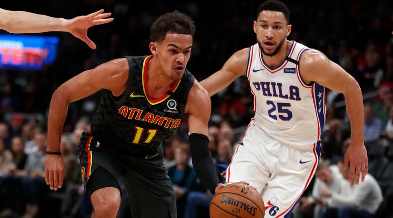 Hawks guard Trae Young (11) drives past Sixers guard Ben Simmons (25) during first half of an NBA basketball game Thursday, Jan. 30, 2020, in Atlanta.